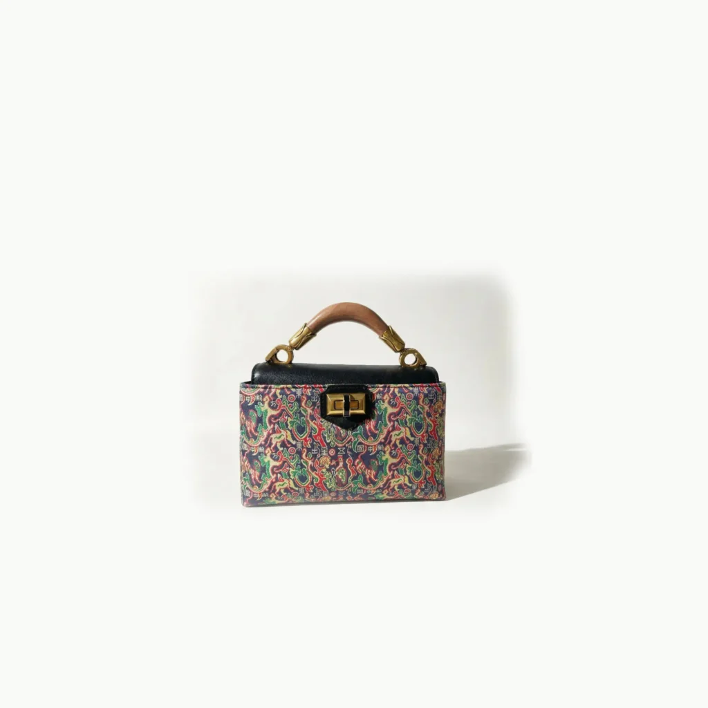 High-end artisanal bag in [Songjin] Song Brocade, featuring ancient auspicious celestial patterns, premium heritage silk accessory for sustainable luxury fashion.